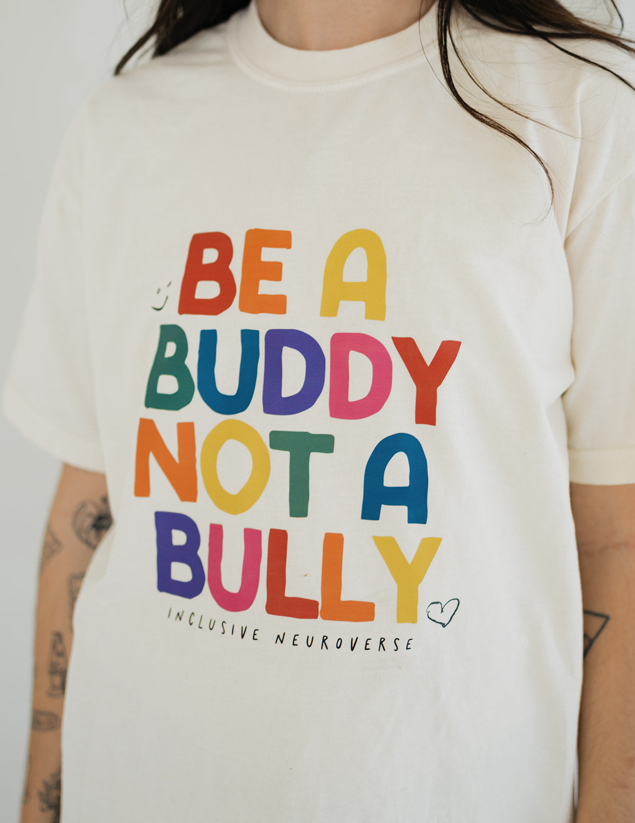 Close-up of Be a Buddy Not a Bully slogan on sensory-friendly adult advocacy shirt by Inclusive Neuroverse