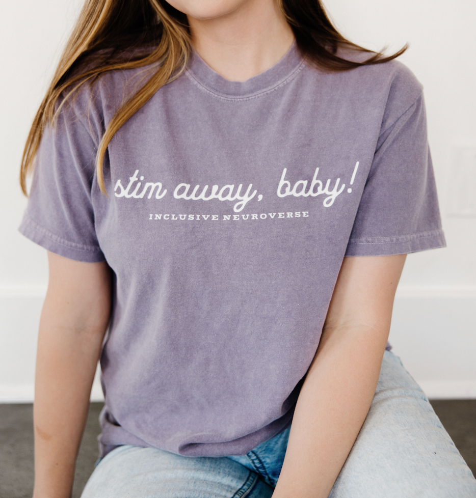 Adult wearing the Stim Away Baby heavyweight t-shirt, showcasing sensory-friendly neurodiversity apparel for autism acceptance